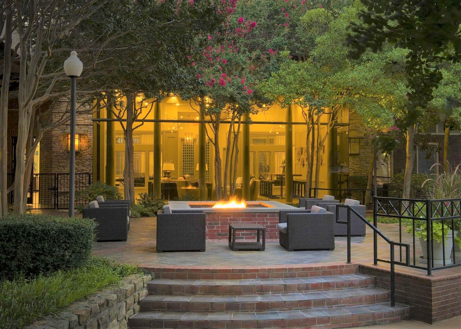 Fire pit lounge area by swimming pool at Mission Gate Apartments Plano TX